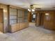 Living room with wood paneling, built-in shelving and access to other rooms at 8725 Bringle Ferry Rd, Salisbury, NC 28146