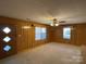 Living room with wood paneling, and diamond shaped door at 8725 Bringle Ferry Rd, Salisbury, NC 28146