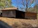 Wooden outbuilding with single door and gabled roof at 8725 Bringle Ferry Rd, Salisbury, NC 28146