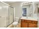 Bathroom with a shower and tub, sleek vanity, and an open doorway showing a view of the adjacent bedroom at 10238 Highland Creek Cir, Fort Mill, SC 29707