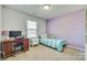 Cozy bedroom featuring a comfortable bed, a desk for work or study, and a window for natural light at 10238 Highland Creek Cir, Fort Mill, SC 29707