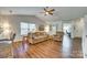 Spacious living area boasts hardwood floors, neutral walls, a sectional couch, and flows seamlessly into the kitchen at 10238 Highland Creek Cir, Fort Mill, SC 29707