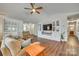 Open living area featuring hardwood floors, a ceiling fan, a comfortable sofa and built-in cabinets at 10238 Highland Creek Cir, Fort Mill, SC 29707