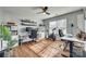 Bright, well-lit home office with wood floors, multiple desks, shelves, and a large window for natural light at 10238 Highland Creek Cir, Fort Mill, SC 29707