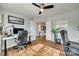 Bright office featuring wood floors, two desks, open doors, and a ceiling fan at 10238 Highland Creek Cir, Fort Mill, SC 29707