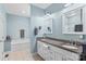 This bathroom features a double sink with granite countertop, white cabinets, and a soaking tub at 103 Granville Ln, Salisbury, NC 28146