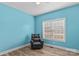 The blue bedroom has a black leather recliner, wood-look floors, and a window with blinds at 103 Granville Ln, Salisbury, NC 28146