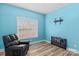 The blue bedroom has a black leather recliner, wood-look floors, and a window with blinds at 103 Granville Ln, Salisbury, NC 28146