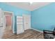 This bedroom features wood-look floors, blue walls, and includes a storage area and closet at 103 Granville Ln, Salisbury, NC 28146