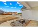 View from porch: a well-kept lawn, and a charming home with a stone fire pit near the entrance at 103 Granville Ln, Salisbury, NC 28146