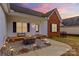 Cozy front porch area featuring a modern fire pit, stone landscaping, and welcoming bench seating at 103 Granville Ln, Salisbury, NC 28146