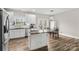 Bright kitchen with white cabinets, stainless steel appliances, a kitchen island, and dining area with backyard views at 103 Granville Ln, Salisbury, NC 28146