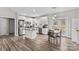 Bright kitchen features stainless steel appliances, white cabinets, and an island with an eat-in dining area at 103 Granville Ln, Salisbury, NC 28146