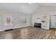 Spacious living room featuring vaulted ceilings, wood-look floors, and lots of natural light from the front door and window at 103 Granville Ln, Salisbury, NC 28146