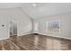 Bright living room with vaulted ceilings, wood-look flooring, and an open layout leading to other rooms at 103 Granville Ln, Salisbury, NC 28146