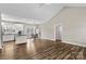 Open concept living space with vaulted ceilings, wood floors, and a seamless flow to the modern kitchen at 103 Granville Ln, Salisbury, NC 28146