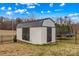 Storage shed with dark crossbuck doors, providing ample room for tools and equipment at 103 Granville Ln, Salisbury, NC 28146