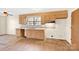 Galley kitchen with wood cabinets and laminate floors at 115 E Geroid St, Salisbury, NC 28144