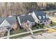 An aerial shot showcasing the home's roof and landscaping in a desirable neighborhood with mature trees at 11508 Dublin Crescent Rd, Cornelius, NC 28031