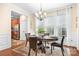 Inviting dining room with a large window and view of the modern kitchen at 11508 Dublin Crescent Rd, Cornelius, NC 28031