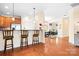 Open kitchen view with bar seating, stainless steel appliances, and hardwood floors throughout at 11508 Dublin Crescent Rd, Cornelius, NC 28031