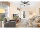 A cozy living room with tile flooring, a comfortable leather sofa, and lots of natural light at 11508 Dublin Crescent Rd, Cornelius, NC 28031