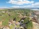 Expansive aerial view of the community featuring lush trees, community pool, and lake views at 117 Cove Pointe, Mount Holly, NC 28120