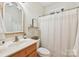 This bathroom has a single sink and shower/tub with curtain at 117 Cove Pointe, Mount Holly, NC 28120