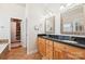 Bathroom with double sinks, granite counters, and a walk-in closet access at 117 Cove Pointe, Mount Holly, NC 28120