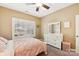 This bedroom features a ceiling fan and a large window for natural light at 117 Cove Pointe, Mount Holly, NC 28120