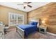 This bedroom features a wood accent wall and a ceiling fan at 117 Cove Pointe, Mount Holly, NC 28120