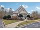 Attractive community clubhouse with stone accents, well-manicured landscaping, and welcoming entrance at 117 Cove Pointe, Mount Holly, NC 28120