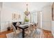 Elegant dining room with modern chandelier, wainscoting, and large window at 117 Cove Pointe, Mount Holly, NC 28120