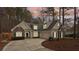 Inviting home with stone accents, manicured landscaping, and a long driveway surrounded by mature trees at 117 Cove Pointe, Mount Holly, NC 28120