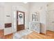 Bright foyer with wood floors, decorative mirror, and frosted glass front door at 117 Cove Pointe, Mount Holly, NC 28120