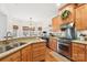 Well-lit kitchen with stainless steel appliances, granite countertops, and ample wood cabinetry at 117 Cove Pointe, Mount Holly, NC 28120