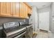 This laundry room features newer machines and plenty of cabinet space at 117 Cove Pointe, Mount Holly, NC 28120