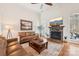 Cozy living room with stone fireplace, hardwood floors, and plenty of natural light at 117 Cove Pointe, Mount Holly, NC 28120