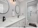 Modern bathroom with double vanity, white cabinets and frameless shower at 121 Quality Dr, Mount Holly, NC 28120