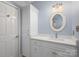 Bathroom with white vanity, quartz countertop, and oval mirror at 121 Quality Dr, Mount Holly, NC 28120