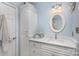 Bathroom with white vanity, quartz countertop, and oval mirror at 121 Quality Dr, Mount Holly, NC 28120