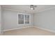 Well-lit bedroom with ceiling fan and carpet at 121 Quality Dr, Mount Holly, NC 28120