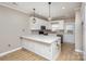 Modern kitchen with white cabinets, quartz countertops, and stainless steel appliances at 121 Quality Dr, Mount Holly, NC 28120