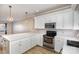 Modern kitchen with white cabinets, quartz countertops, and stainless steel appliances at 121 Quality Dr, Mount Holly, NC 28120