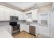 Modern kitchen with white cabinets, quartz countertops, and stainless steel appliances at 121 Quality Dr, Mount Holly, NC 28120