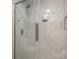 Walk-in shower with marble tile and glass door at 121 Quality Dr, Mount Holly, NC 28120