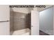 Clean bathroom with gray tile shower and bathtub at 1307 Signal Ave, Gastonia, NC 28052