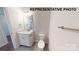 Bathroom with white vanity, toilet, and gray tile floor at 1307 Signal Ave, Gastonia, NC 28052