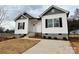 Newly constructed home with gray and white siding, a concrete driveway, and landscaping at 1307 Signal Ave, Gastonia, NC 28052