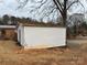 White vinyl-sided storage shed in backyard at 1307 Signal Ave, Gastonia, NC 28052